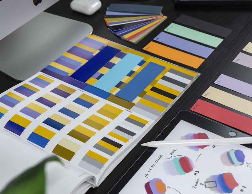Colour swatches and design boards laid out on a studio desk