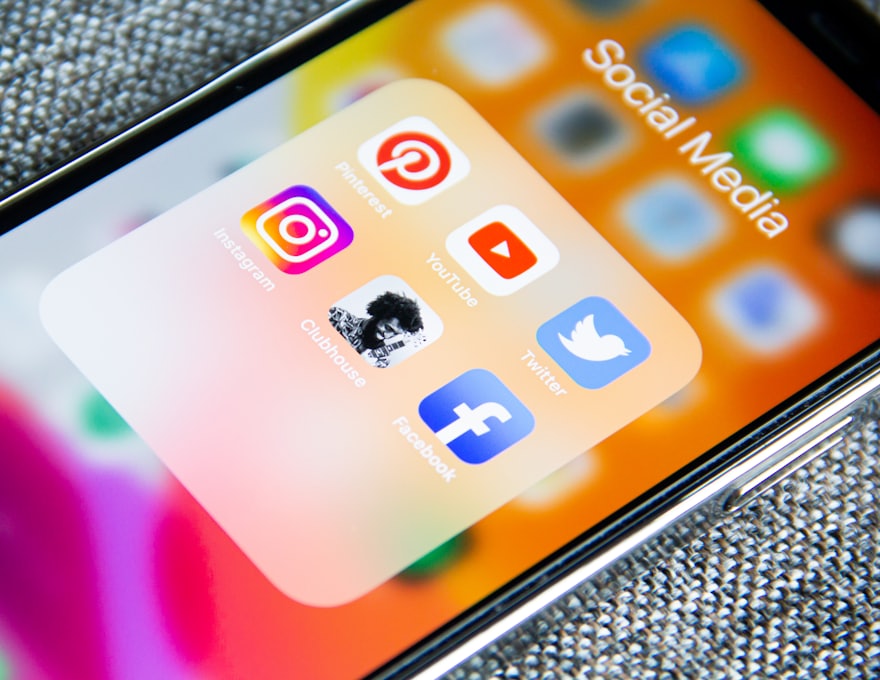 Social media app icons on a phone screen, the channels a campaign runs across