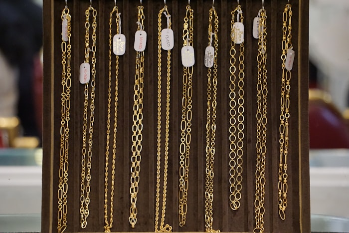 Gold chains displayed in a jewellery showroom, the pieces a catalogue website has to show truthfully